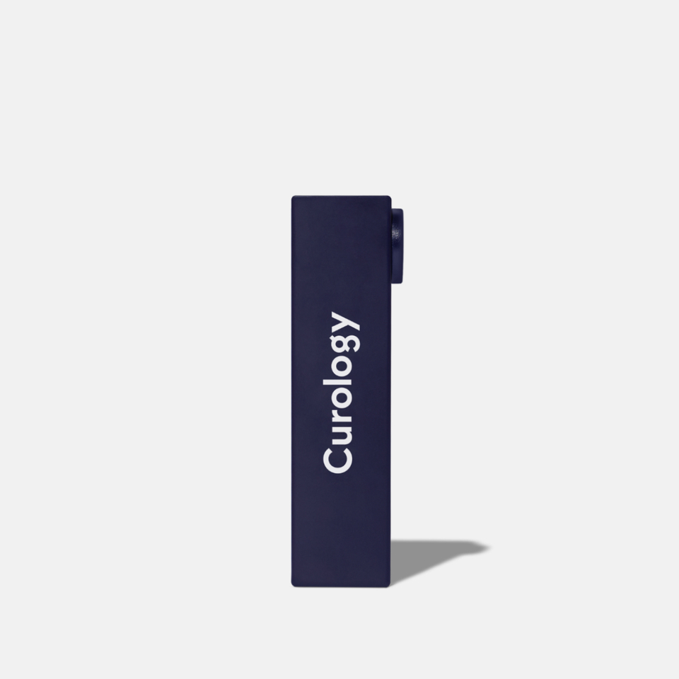 Curology Lip Balm in a slim dark blue rectangular tube with twist-up design, shown from the side with the Curology logo.
